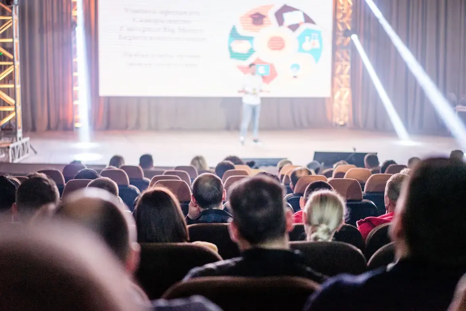An audience watching a presentation at a conference